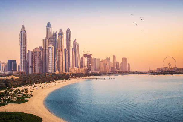 Dubai skyline at sunset with buildings under construction, illustrating off-plan property development.