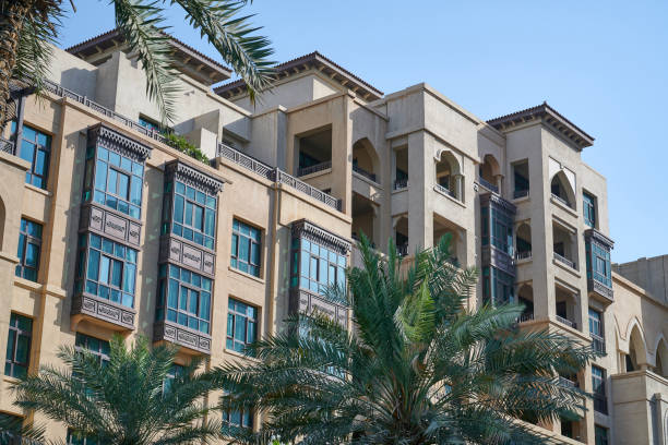 Modern residential building in Dubai, showcasing attractive architecture amidst palm trees.