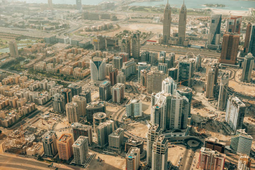 Aerial view of the urban landscape showing ongoing construction in a city area with numerous skyscrapers.